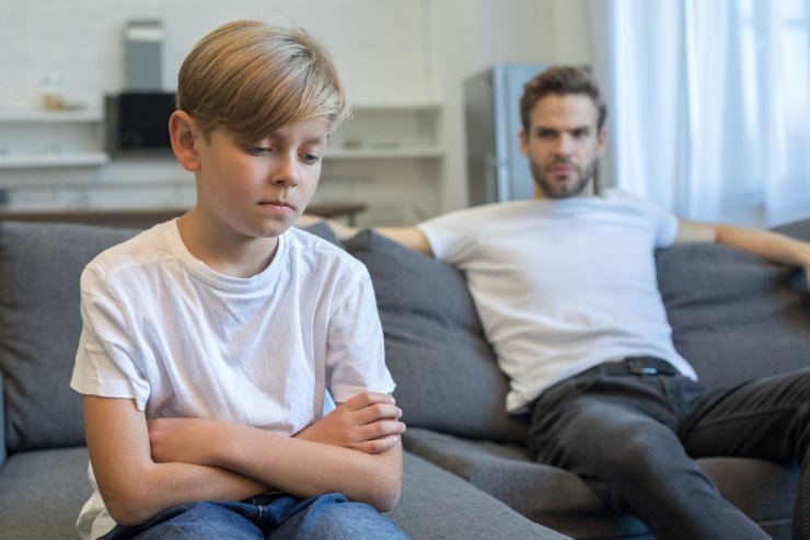 Figlio arrabbiato con il papà, entrambi sul divano