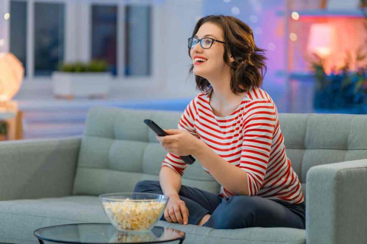 Donna sorridente con telecomando