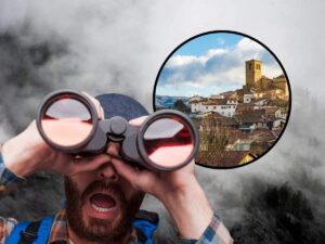 sfondo nuvoloso, tondo con borgo e uomo con binocolo